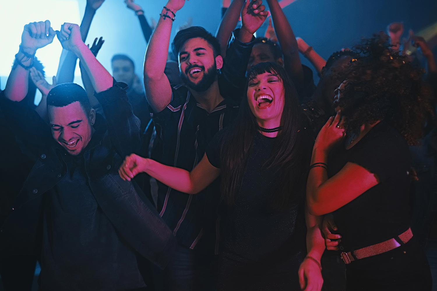 group of friends dancing in a club group of friends dancing in a club