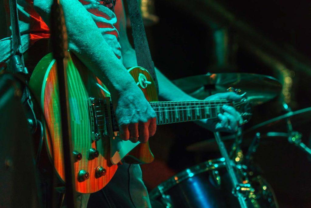 man playing guitar on stage