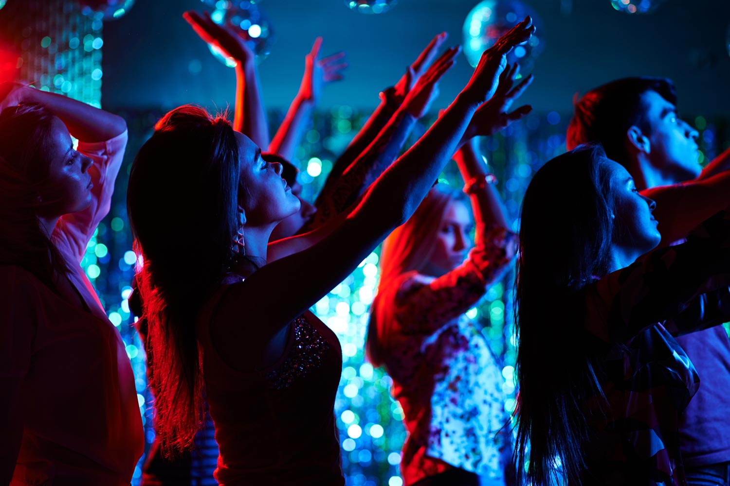 people dancing in a club with their arms in the air people dancing in a club with their arms in the air