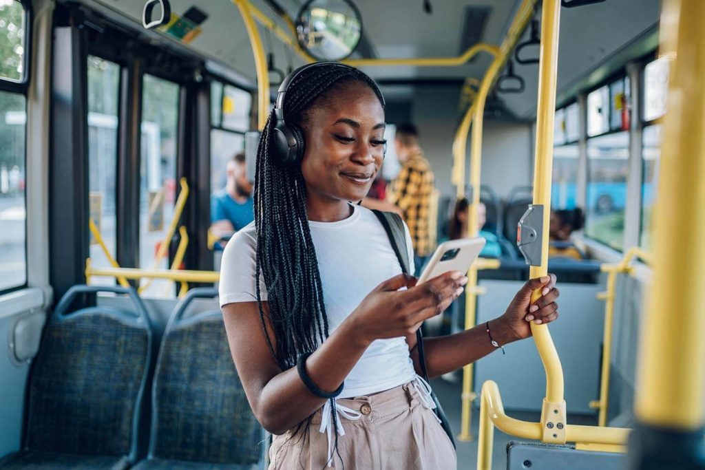young woman on public transport looking at her phone